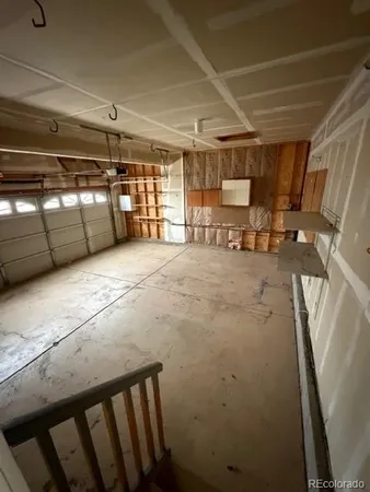 a view of kitchen with furniture and a refrigerator