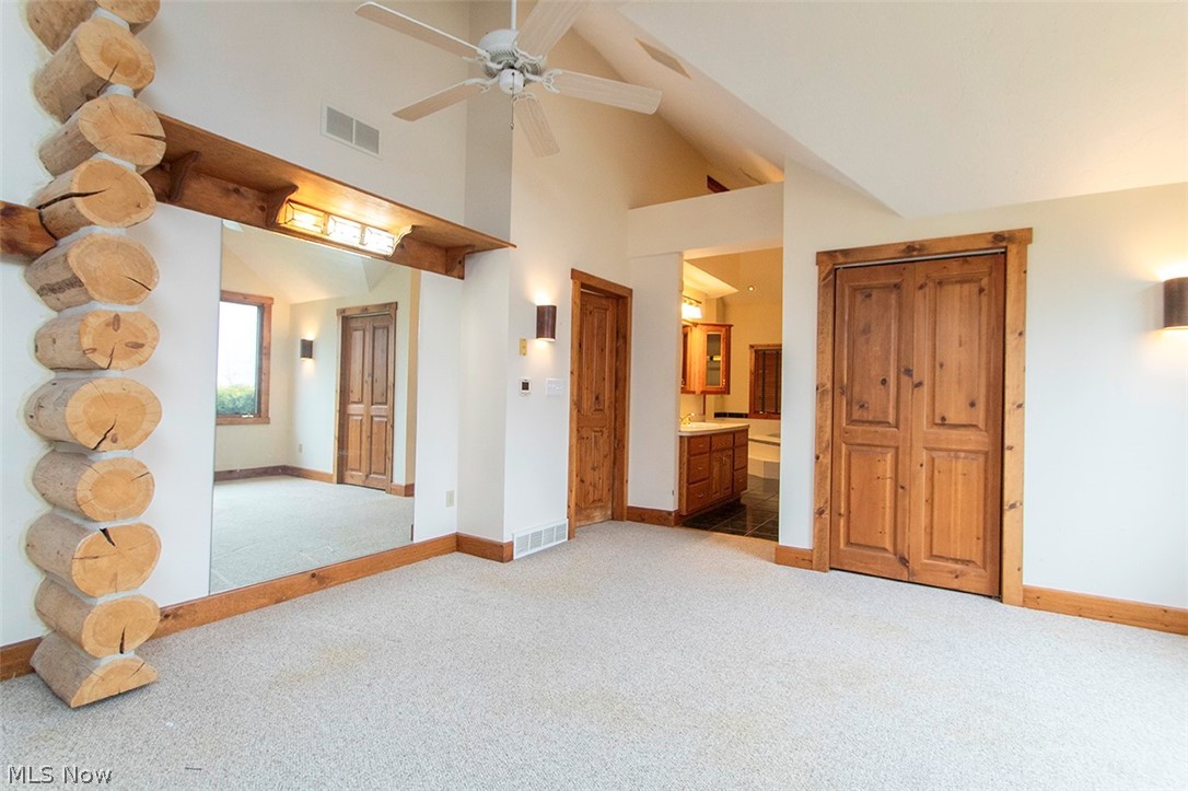 1871 Mattingly Road Hinckley, OH 44233 - Photo 25 of 50 Sitting room featuring light colored carpet, lofted ceiling, a ceiling fan, and ensuite bathroom