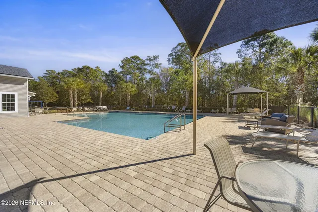 a view of a house with swimming pool and sitting area