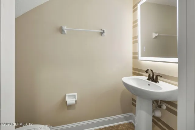 a bathroom with a sink a mirror and a toilet