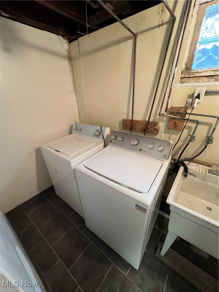 3362 Sutton Road Cleveland, OH 44120 - Photo 35 of 43 Washroom with dark tile patterned flooring, laundry area, a sink, and washing machine and dryer