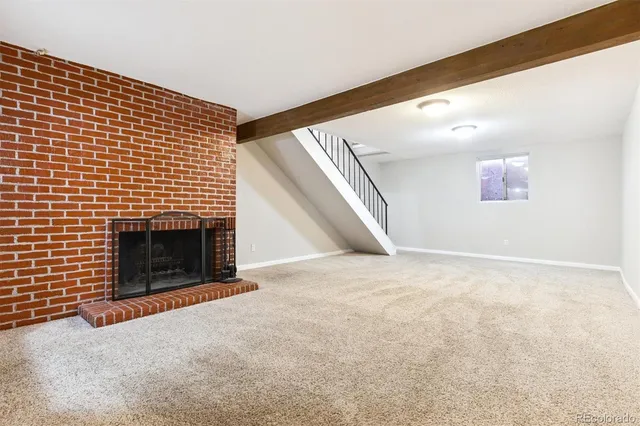a view of an empty room with a fireplace