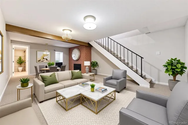 a living room with furniture and a potted plant