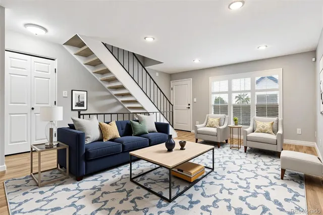 a living room with furniture and wooden floor