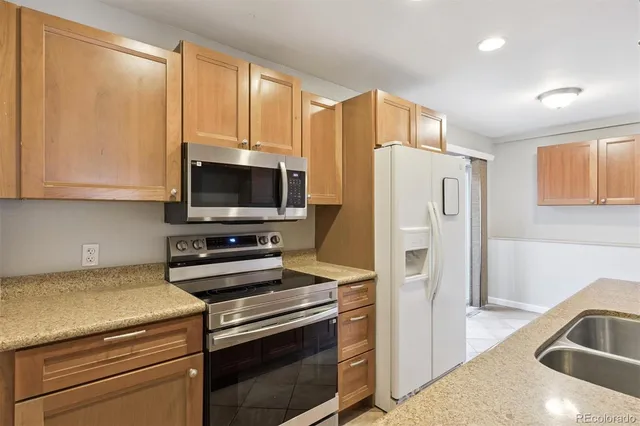 a kitchen with a refrigerator stove and microwave