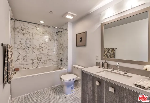 a bathroom with a double vanity sink toilet and shower