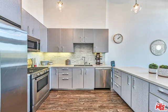 a kitchen with a sink stove and refrigerator