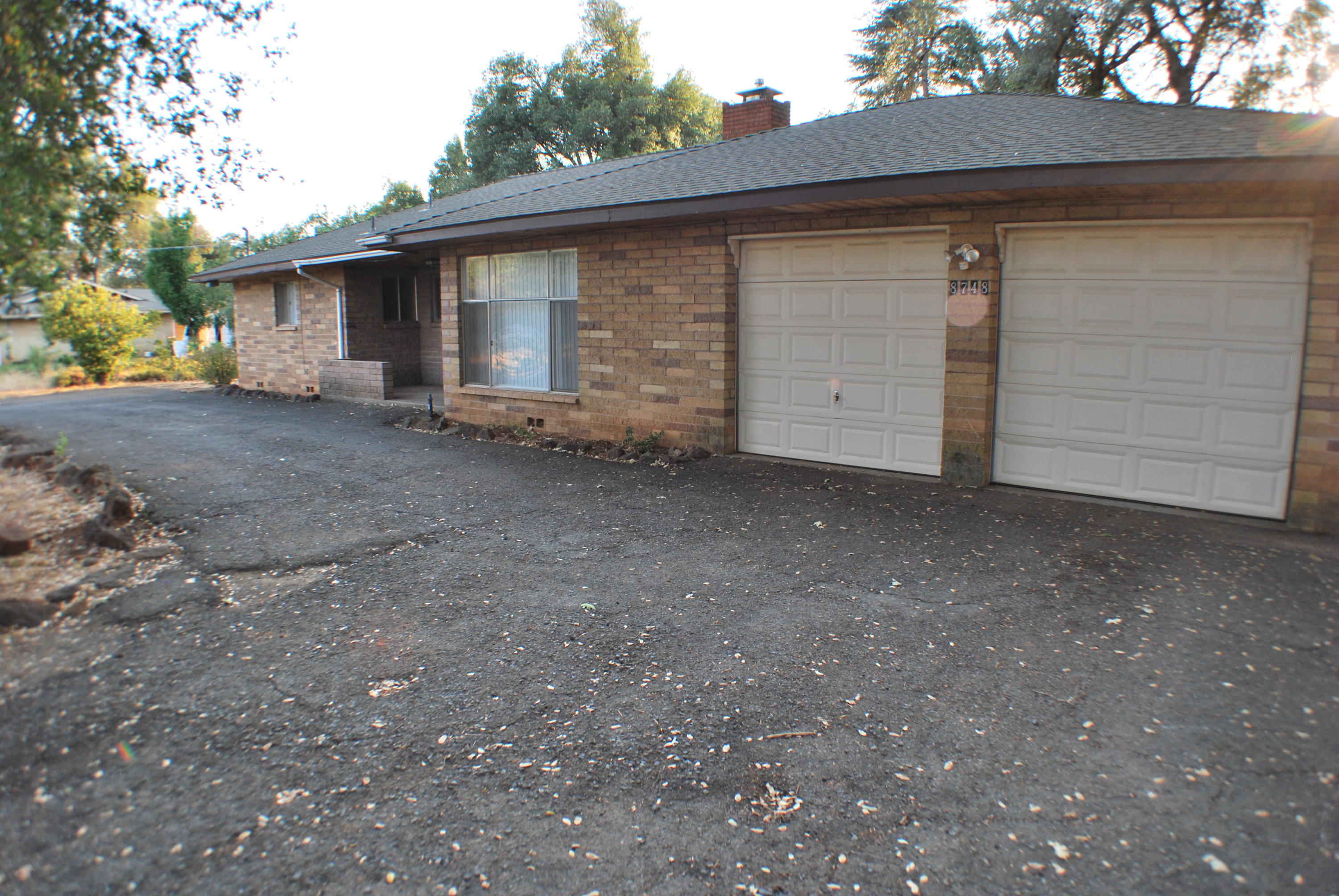 a view of a house with a yard and garage