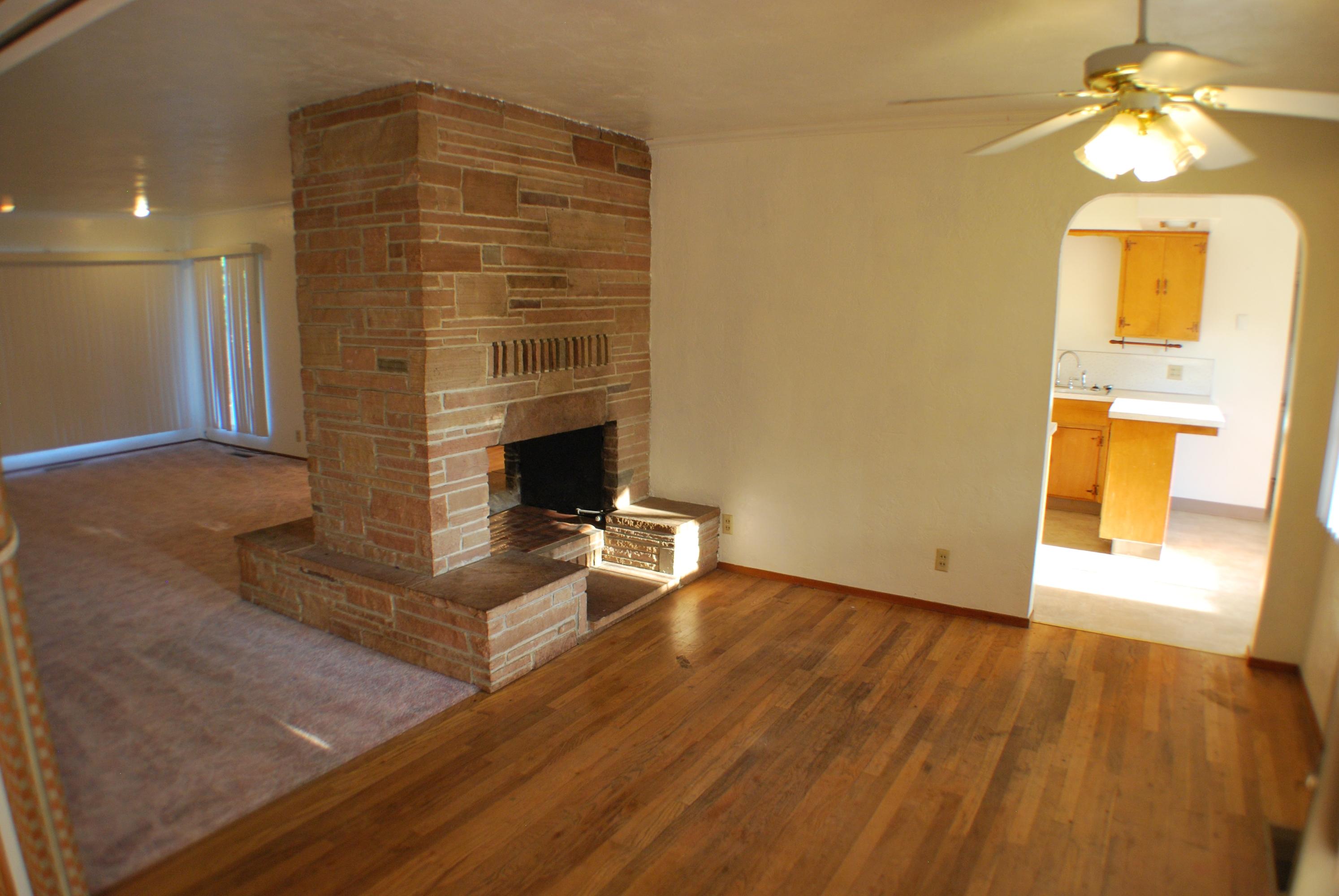 8748 Airport Road Redding, CA 96002 - Photo 3 of 10 wooden floor in an empty room with a window