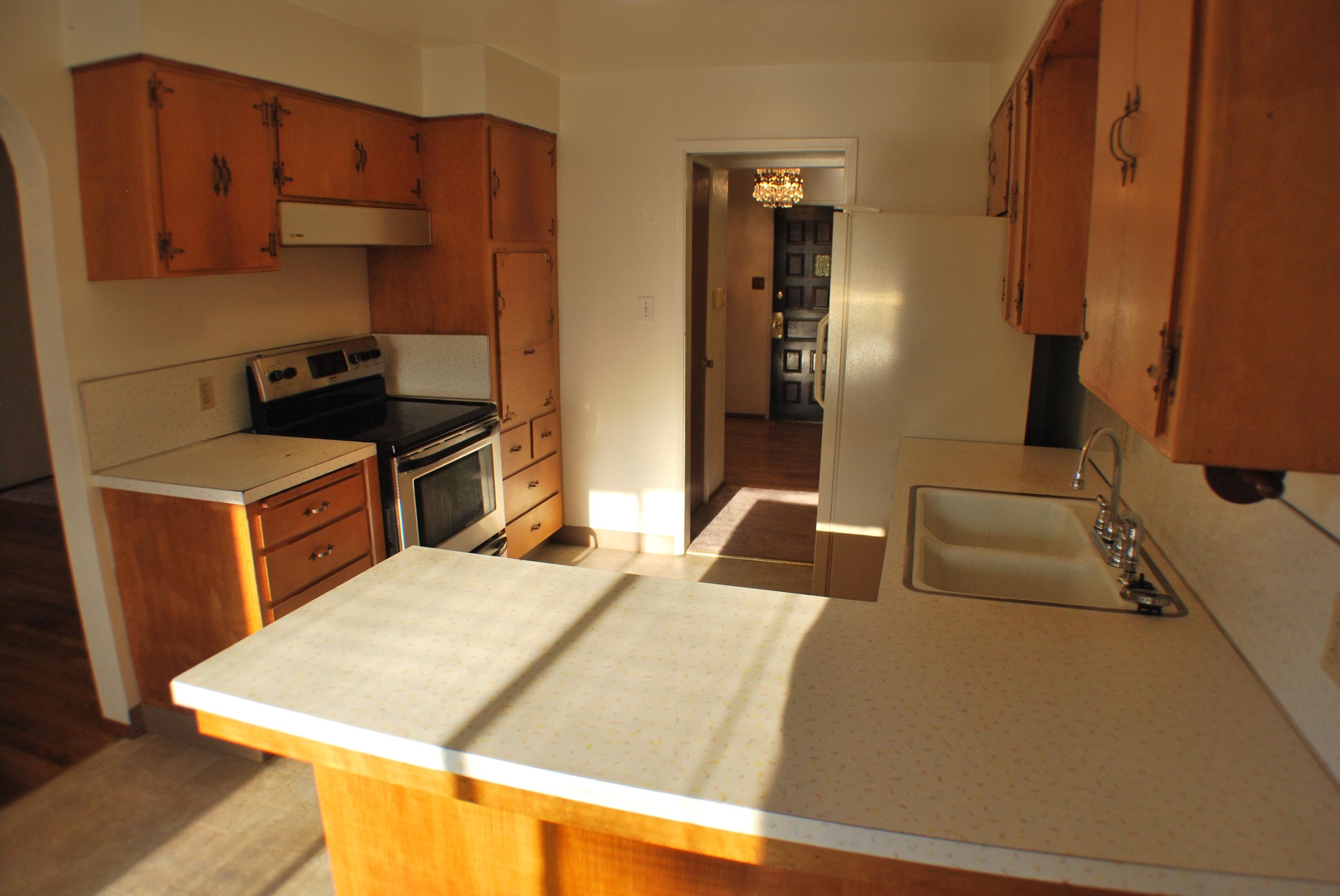 8748 Airport Road Redding, CA 96002 - Photo 5 of 10 a bedroom with a bed and a refrigerator