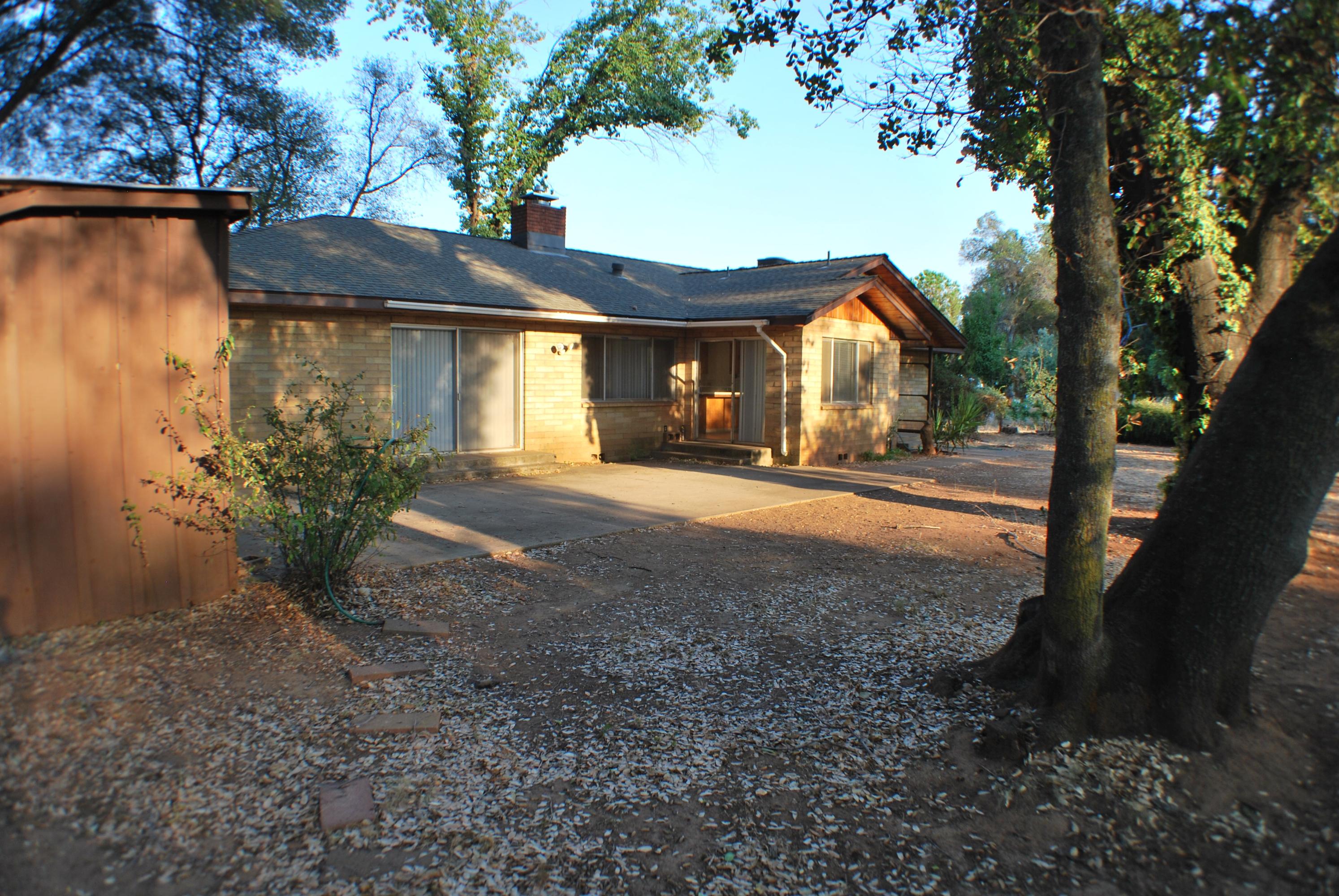 8748 Airport Road Redding, CA 96002 - Photo 7 of 10 a front view of a house with a yard and garage