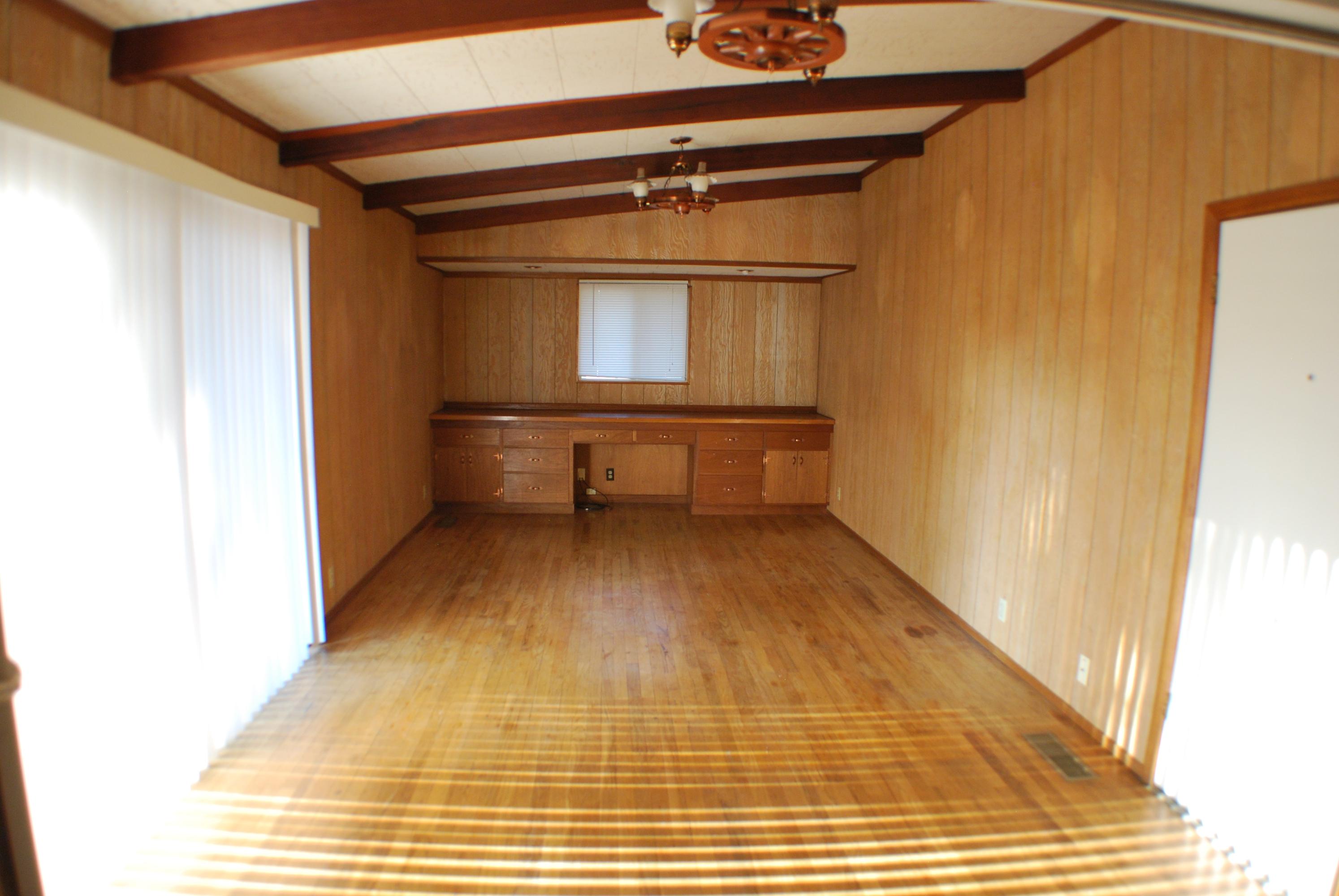 8748 Airport Road Redding, CA 96002 - Photo 9 of 10 a view of a room with wooden floor and furniture