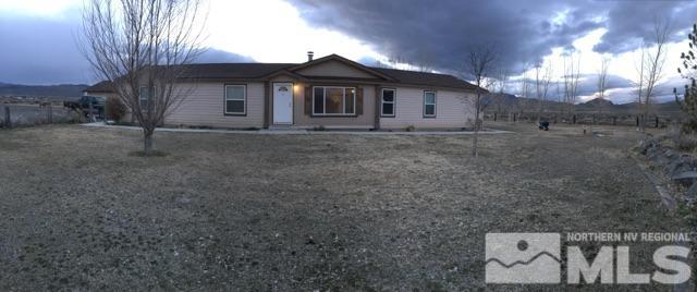 a view of a house with a backyard