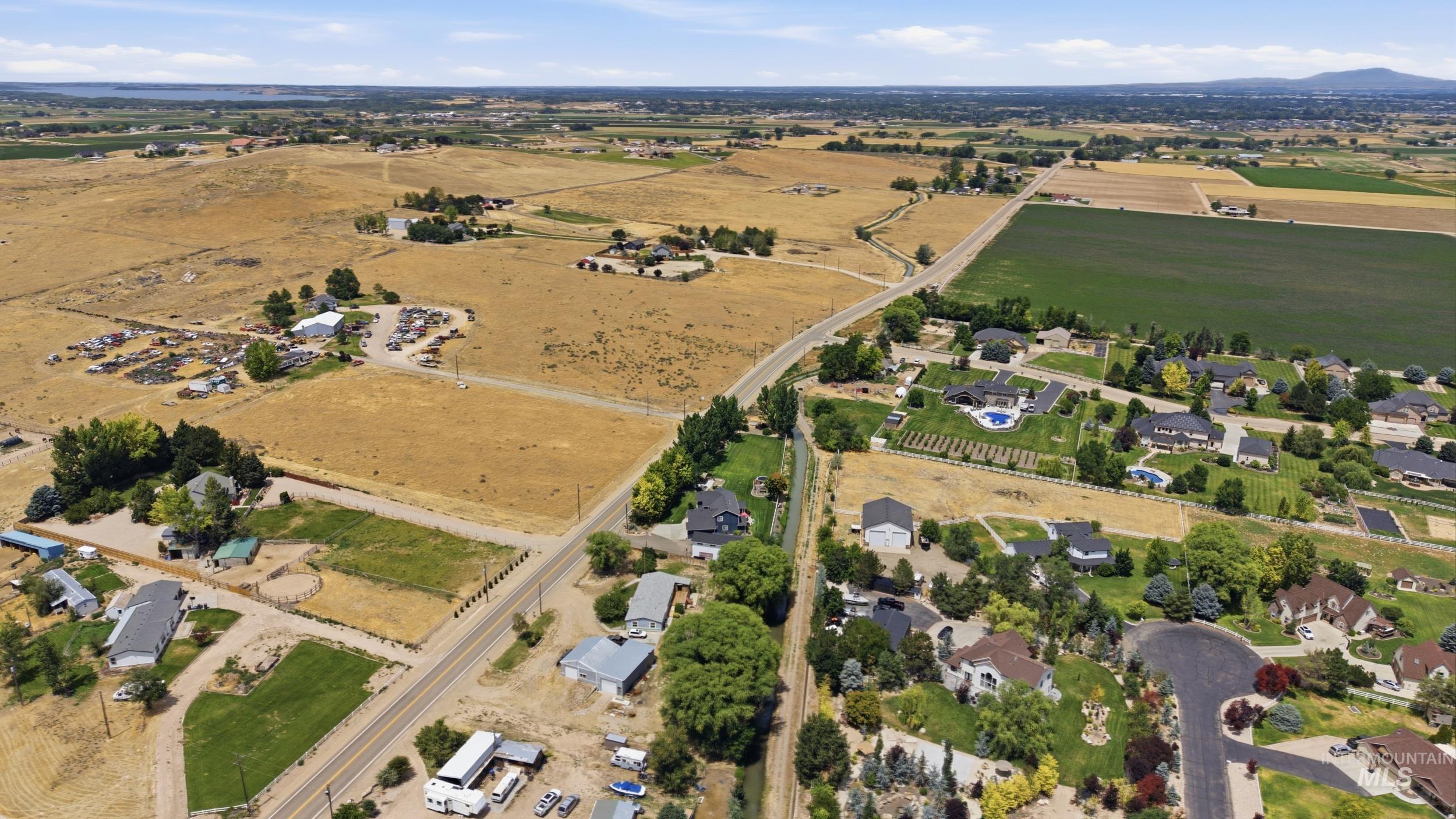 7422 Track Road Nampa, ID 83686 - Photo 46 of 50 Expansive aerial view showcasing residential properties amidst agricultural fields and a mountainous horizon