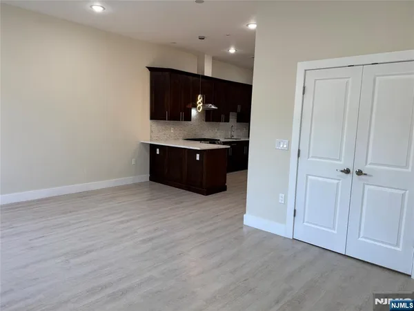a room with a sink and a wooden floor