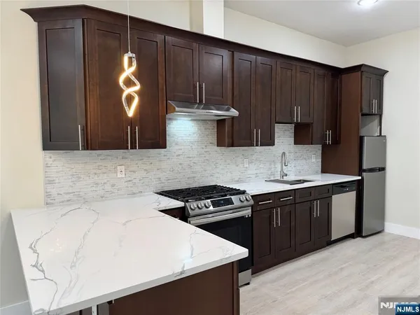 a kitchen with a stove and a refrigerator