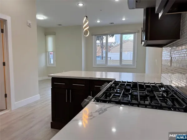 a kitchen with a sink and a stove top oven