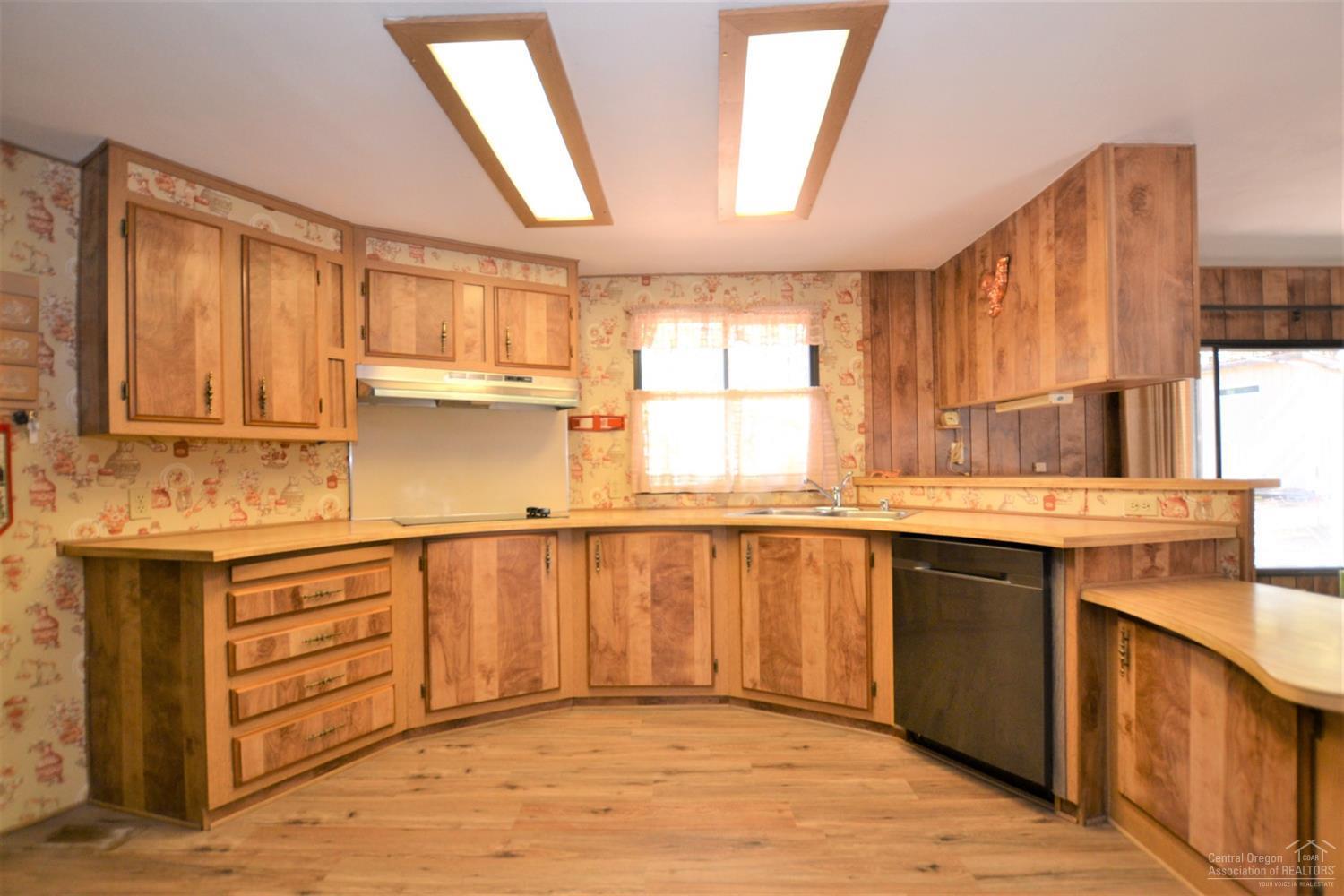 60176 Agate Road Bend, OR 97702 - Photo 9 of 21 a kitchen with granite countertop a sink cabinets and window