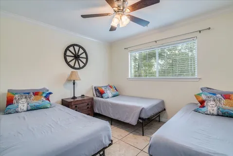 a bedroom with two beds and a chandelier
