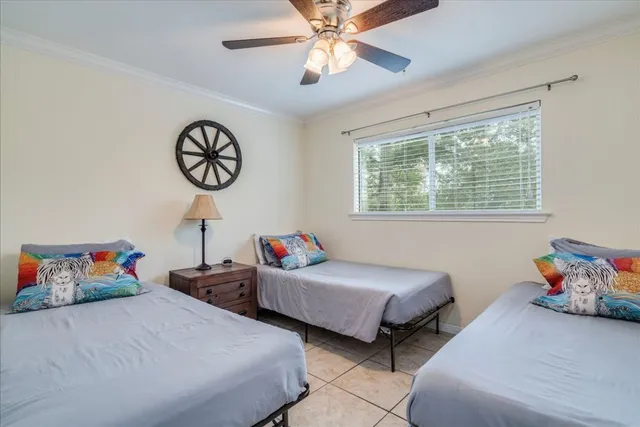a bedroom with two beds and a chandelier