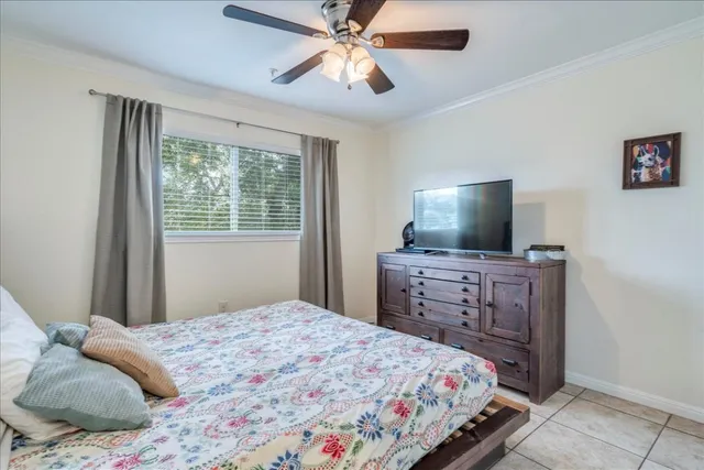 a bedroom with a bed and flat screen tv