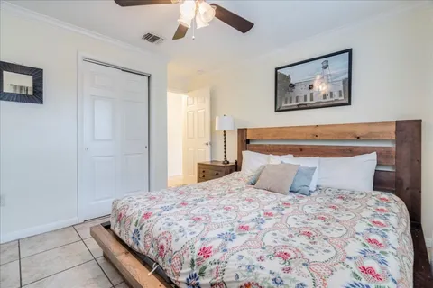 a bedroom with a large bed and a chandelier