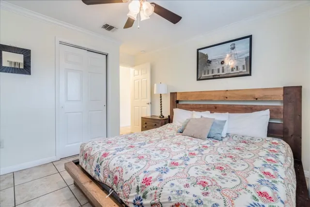 a bedroom with a large bed and a chandelier