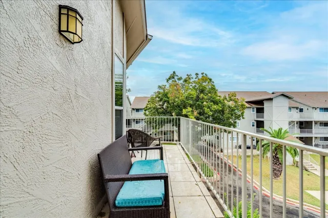 a balcony with table and chairs