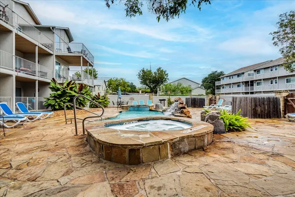 a swimming pool with outdoor seating and plants