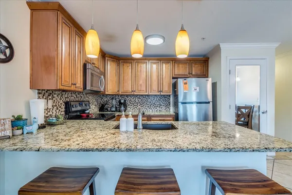 a kitchen with kitchen island granite countertop wooden cabinets and a granite counter tops