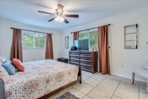 a bedroom with a large bed and a window