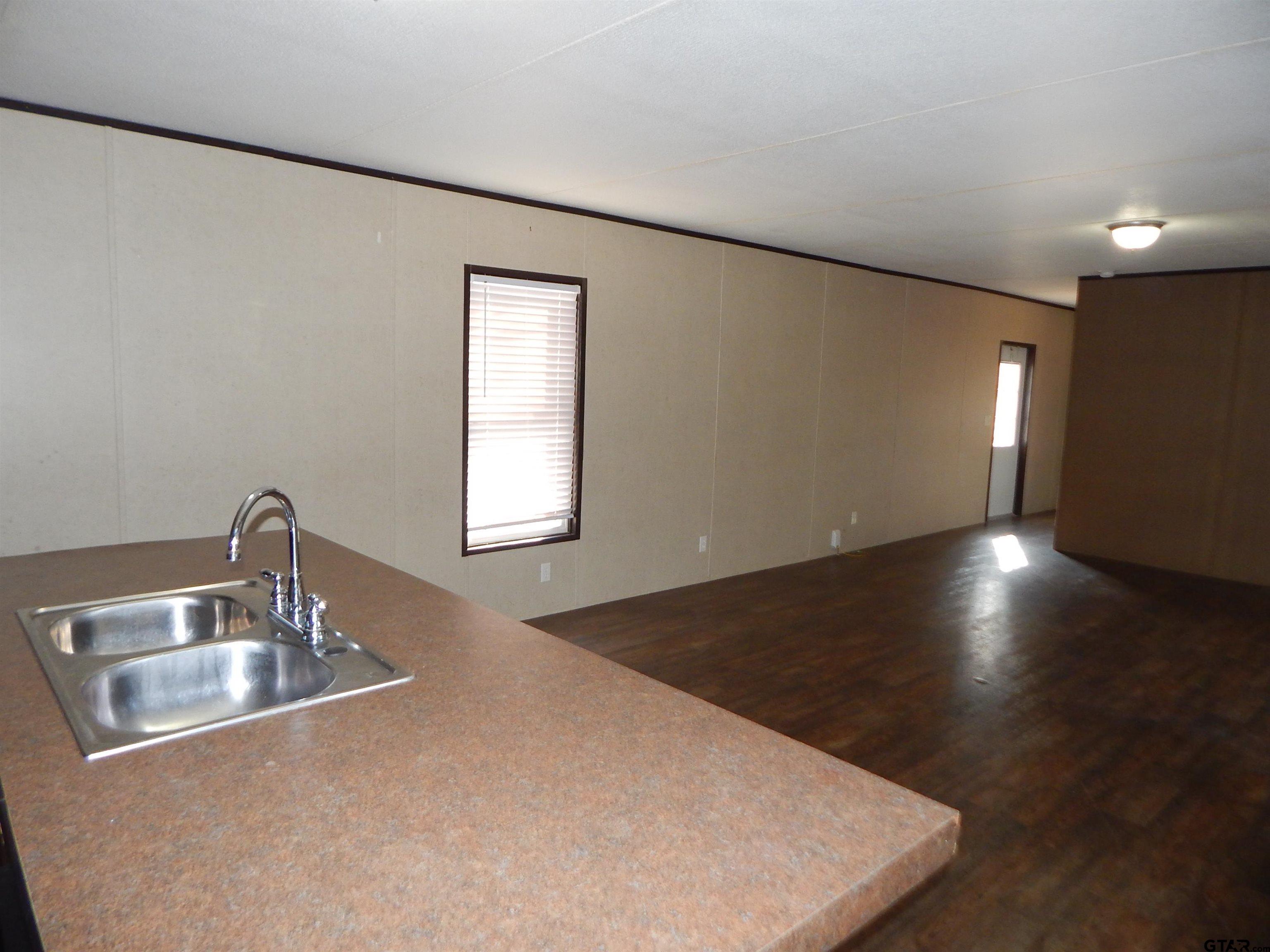 958 Boles Road Gilmer, TX 75645 - Photo 15 of 29 a close view of sink a faucet and appliance in the kitchen