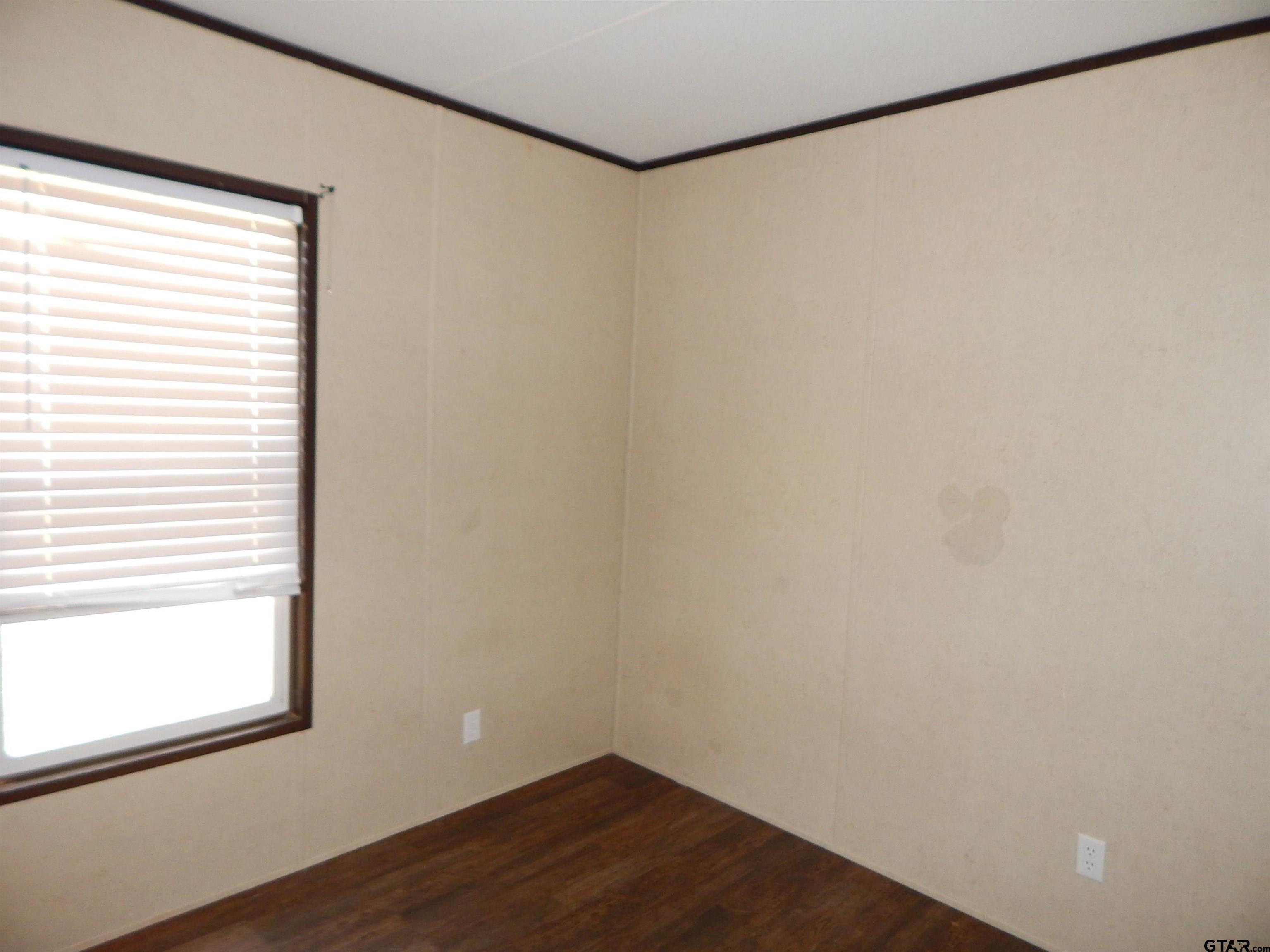958 Boles Road Gilmer, TX 75645 - Photo 17 of 29 a view of a small space with wooden floor and a window