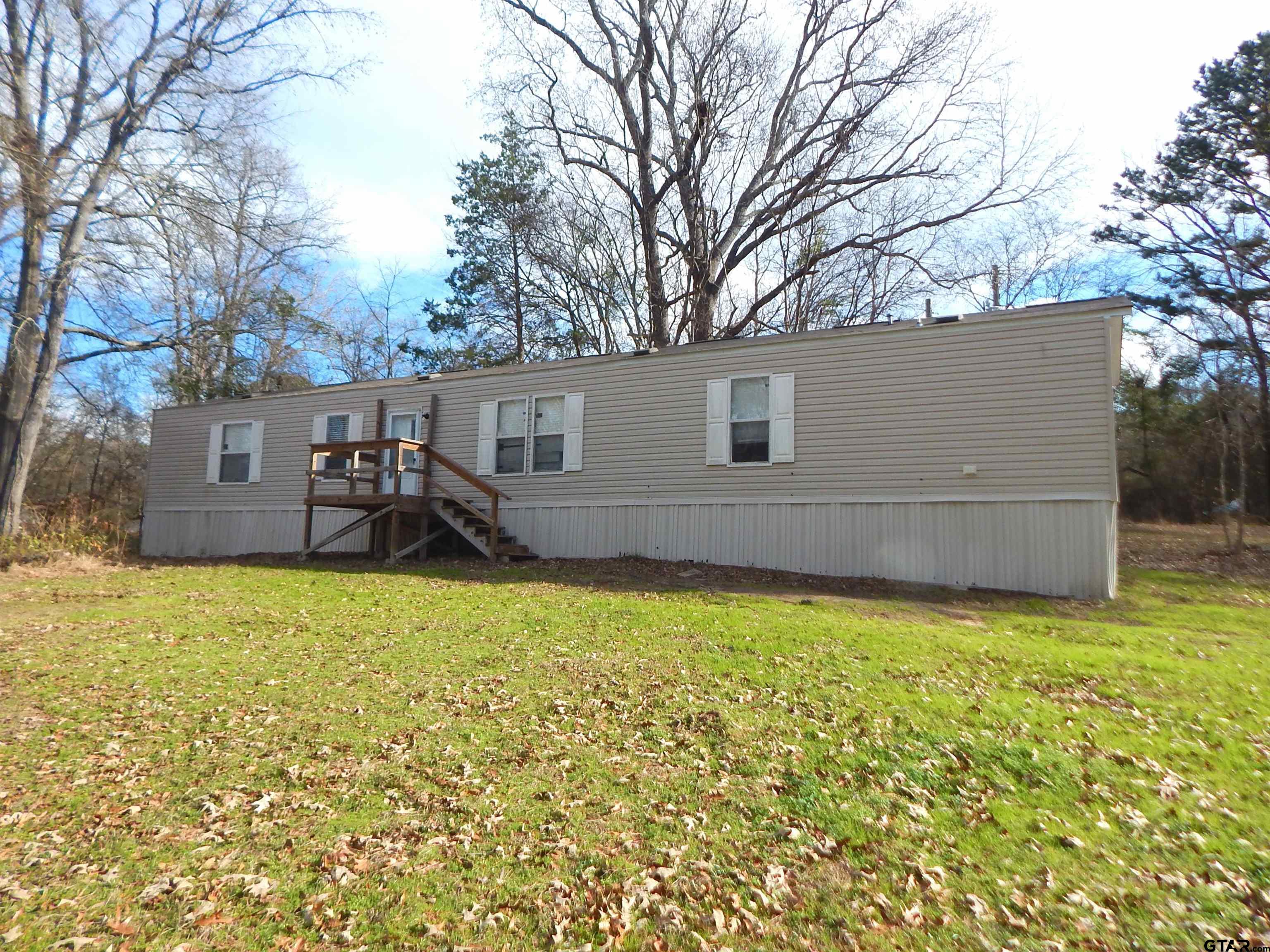 958 Boles Road Gilmer, TX 75645 - Photo 2 of 29 a backyard of a house with table and chairs