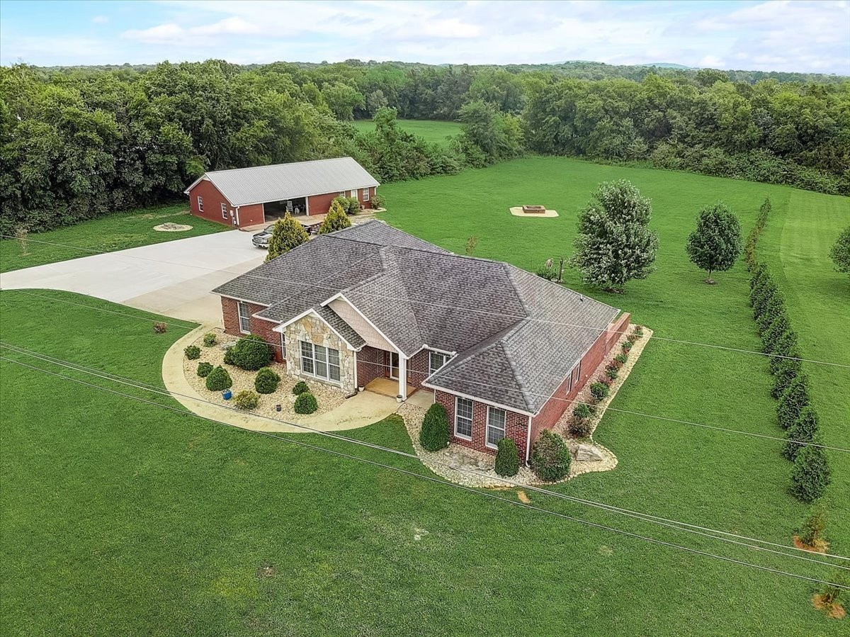 an aerial view of a house with a yard