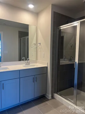 a bathroom with a double vanity sink and mirror