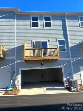 a view of building with car parked
