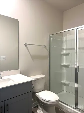 a bathroom with a shower a toilet and a sink