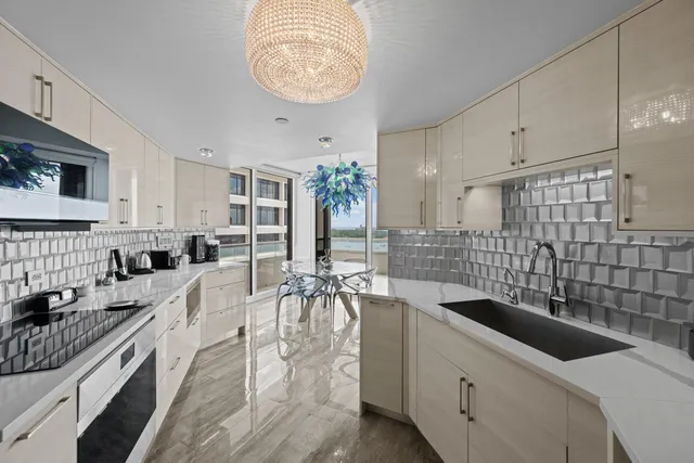 a kitchen with stainless steel appliances granite countertop a sink a stove and a wooden floors