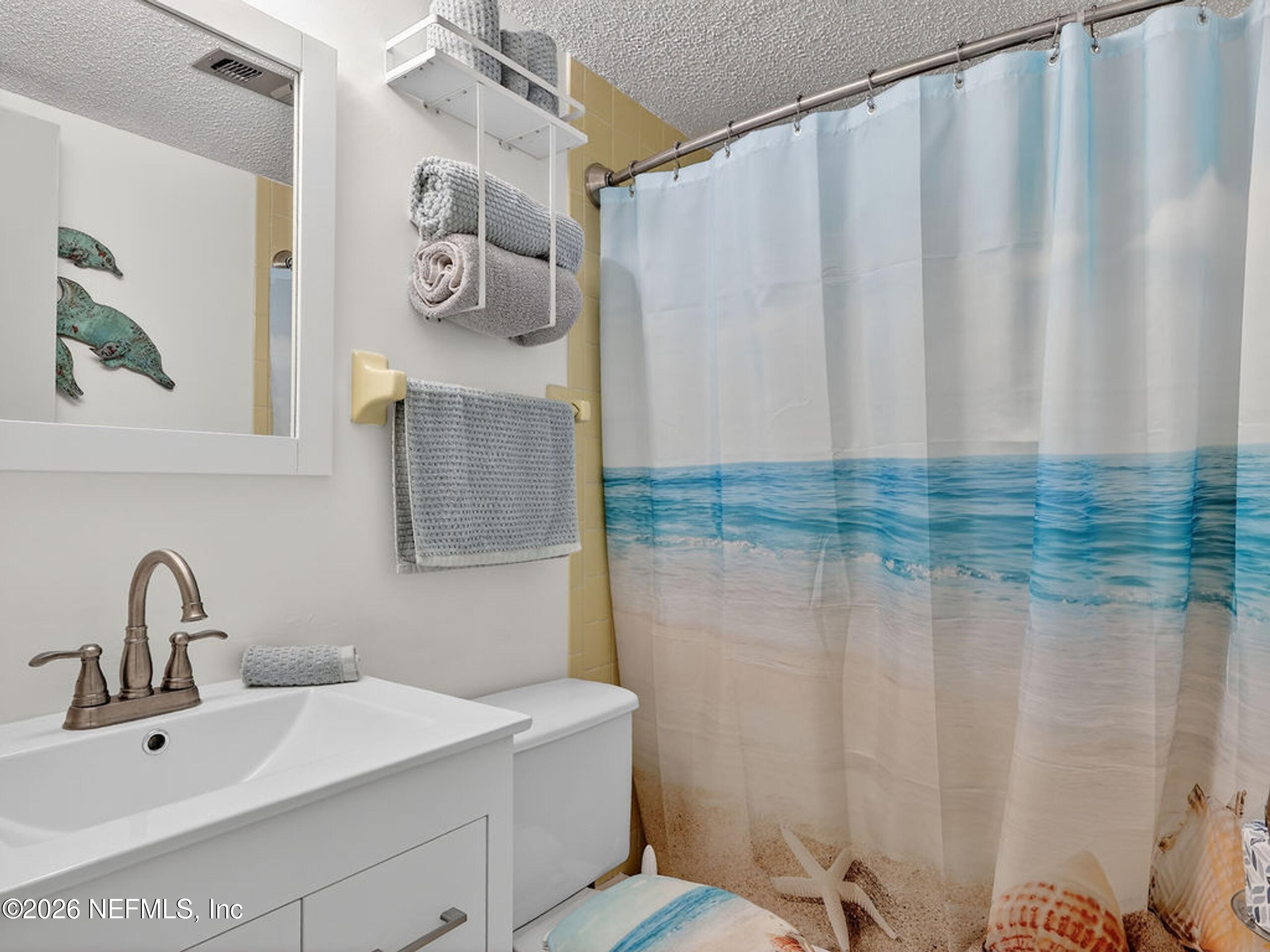 1 Ocean Trace Road, Unit 230 St. Augustine Beach, FL 32080 - Photo 17 of 50 a bathroom with a sink and mirror