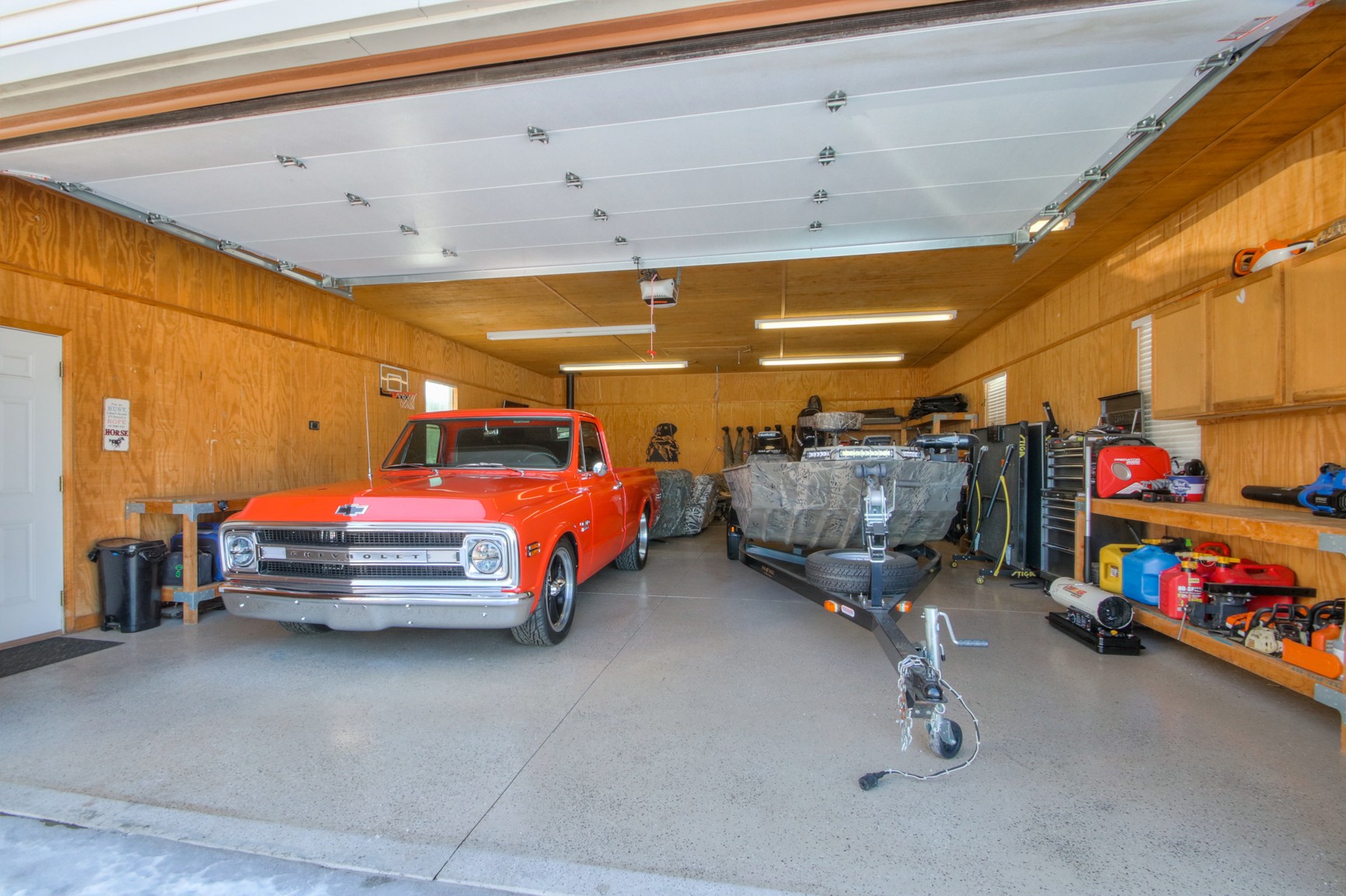 1943 Clara Mathis Road Spring Hill, TN 37174 - Photo 13 of 26 a garage with a car furniture and tools shelf
