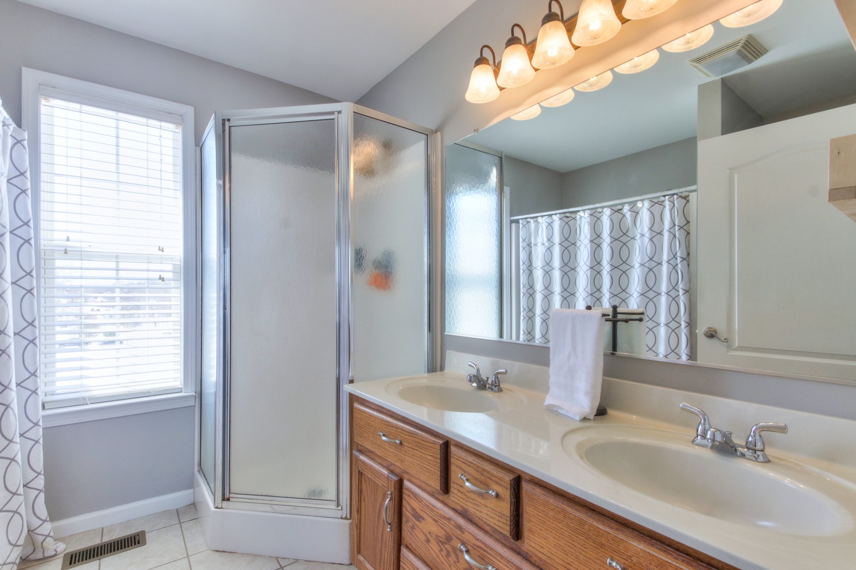 1943 Clara Mathis Road Spring Hill, TN 37174 - Photo 20 of 26 a bathroom with a double vanity sink and a mirror