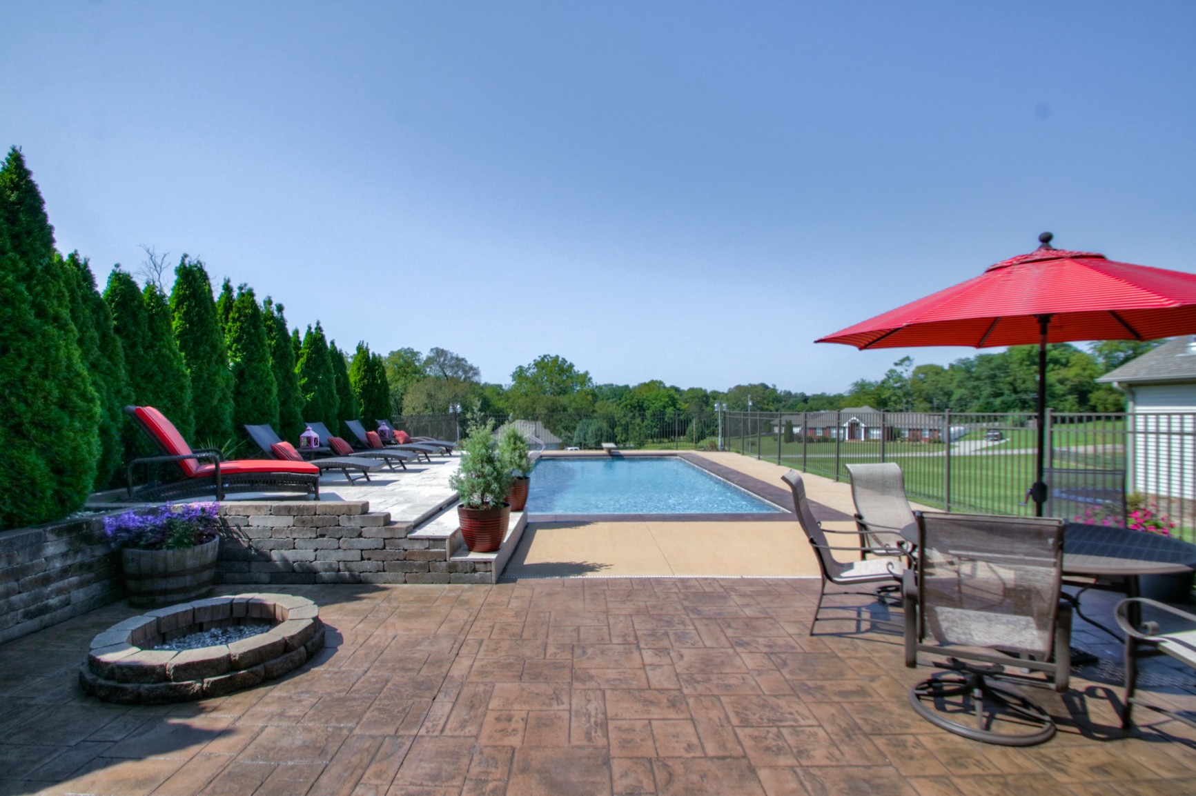 1943 Clara Mathis Road Spring Hill, TN 37174 - Photo 5 of 26 a view of a swimming pool with a table and chairs under an umbrella