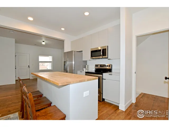 a kitchen with stainless steel appliances granite countertop a sink and a stove