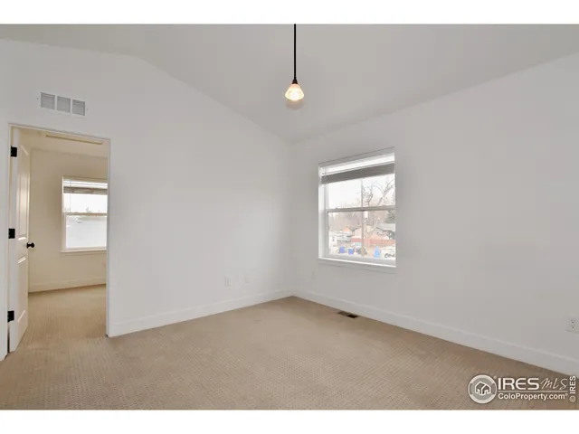 a view of an empty room with windows
