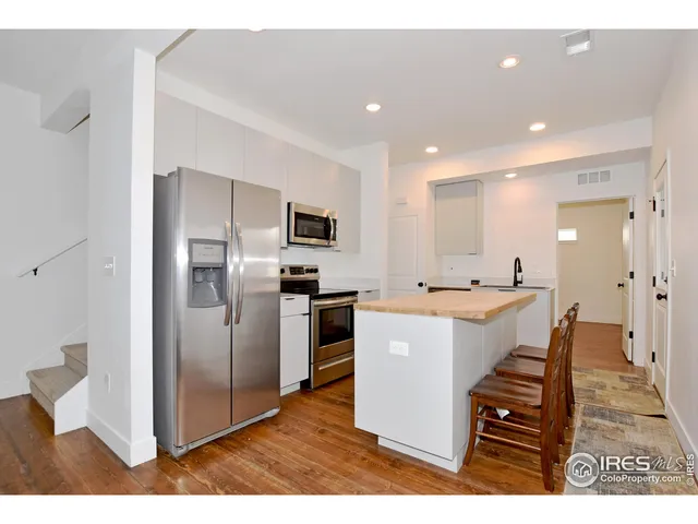 a view of kitchen with refrigerator sink and stove