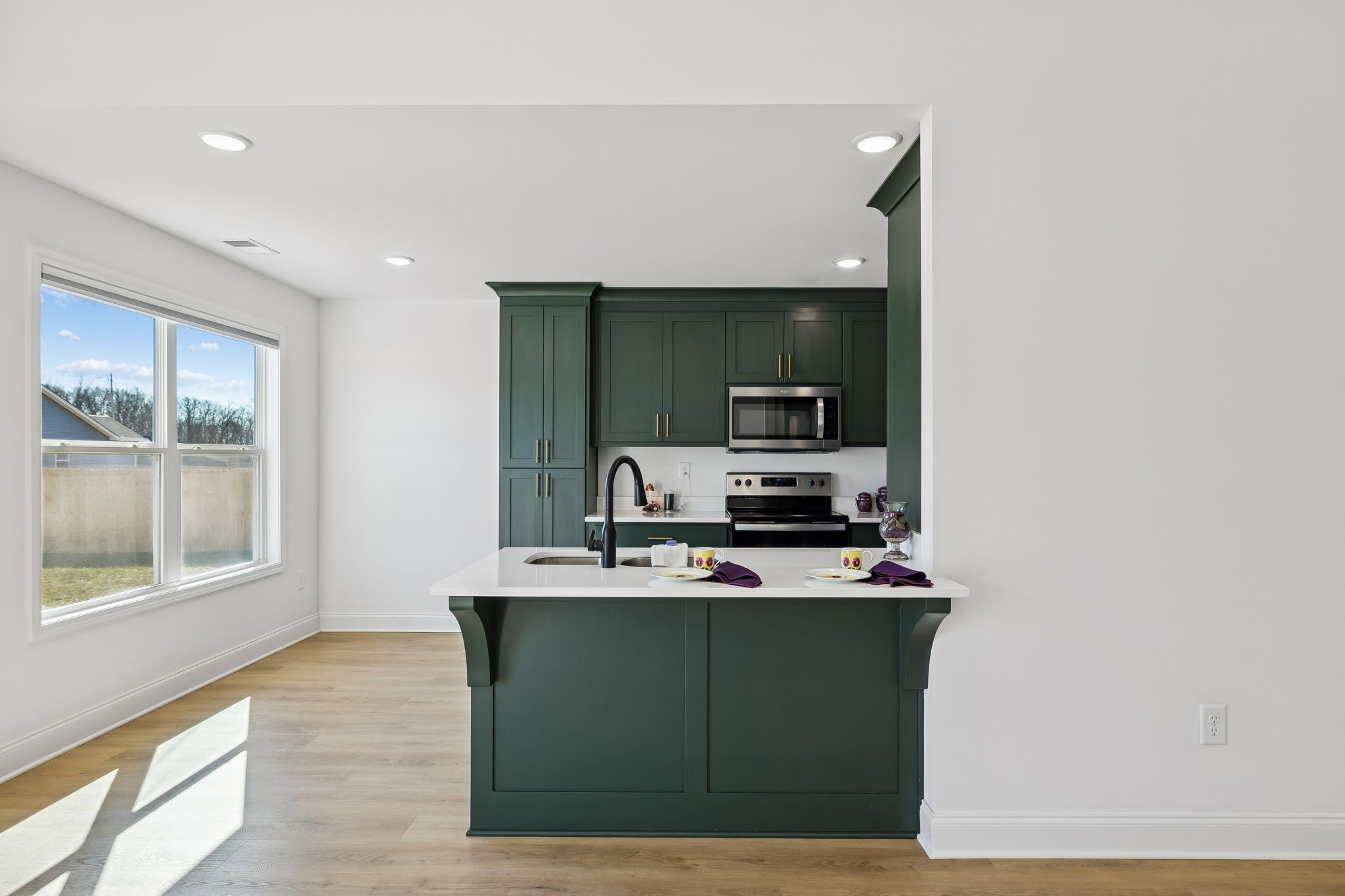 1306 Angus Way Greenbrier, TN 37073 - Photo 24 of 36 a kitchen with kitchen island microwave stove and sink