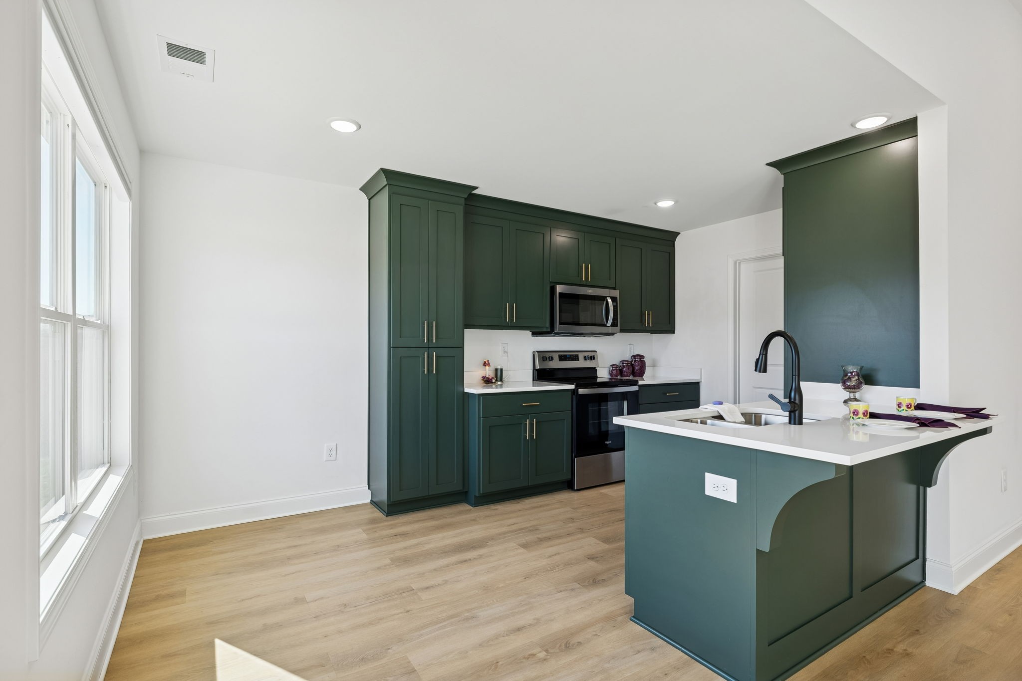 1306 Angus Way Greenbrier, TN 37073 - Photo 25 of 36 a room with kitchen island stainless steel appliances sink stove and refrigerator