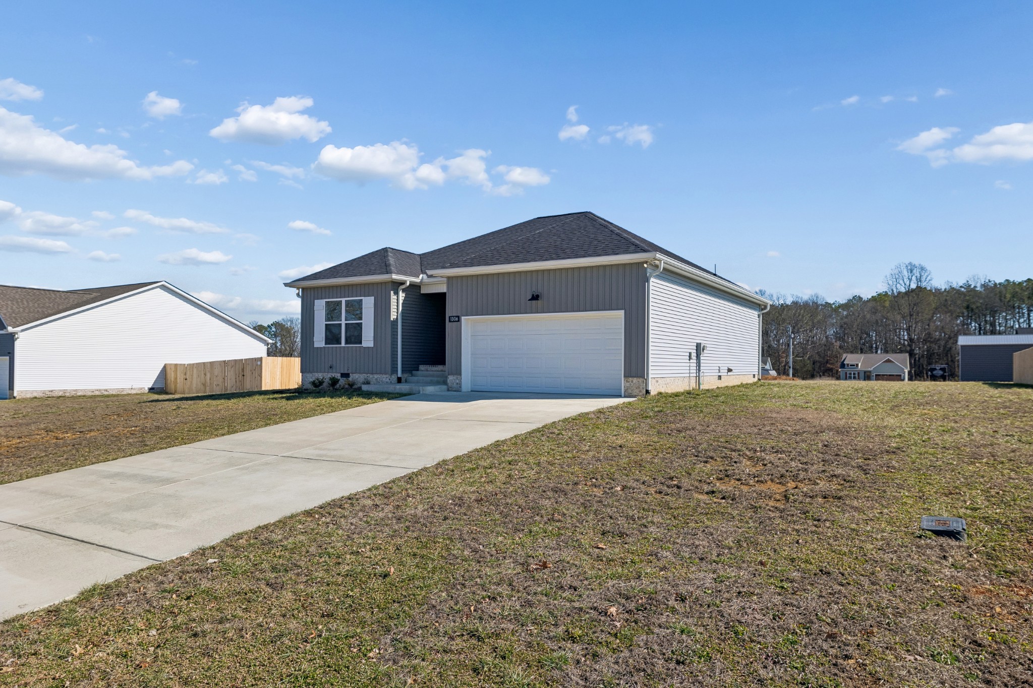 1306 Angus Way Greenbrier, TN 37073 - Photo 5 of 36 a front view of a house with a yard and garage