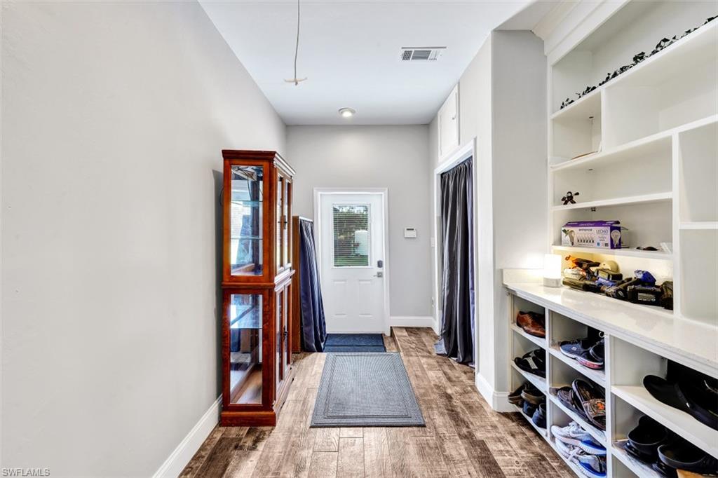 2875 Garland Road Naples, FL 34117 - Photo 11 of 34 a view of a hallway with wooden floor and closet
